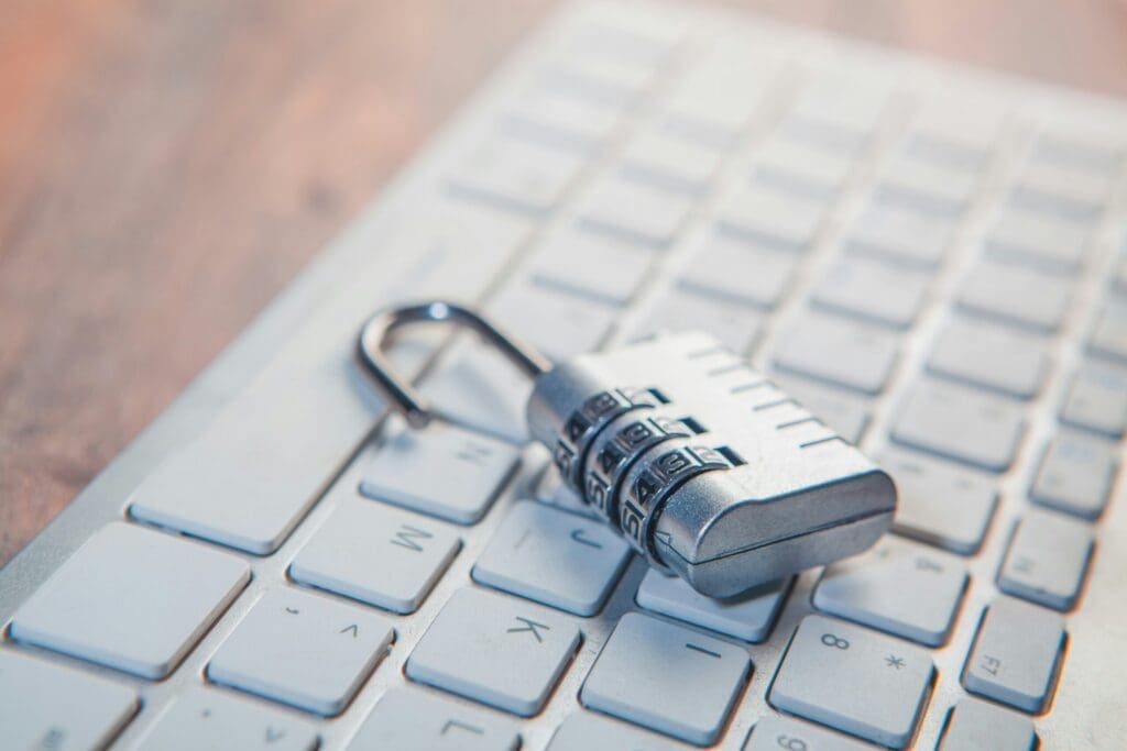 A combination lock rests on a computer keyboard.